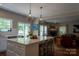 Bright kitchen featuring a large island with seating and views of the living room and backyard at 2090 Durand Rd, Fort Mill, SC 29715