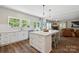 Open-concept kitchen showcases large island with seating, quartz countertops, and a view to living room with fireplace at 2090 Durand Rd, Fort Mill, SC 29715
