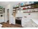 Bright kitchen showcases stainless steel appliances, white cabinets, stylish backsplash, and open shelving with globe decorations at 2090 Durand Rd, Fort Mill, SC 29715