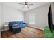 Bright living room with blue sofa, ceiling fan, and hardwood-style floors at 2090 Durand Rd, Fort Mill, SC 29715