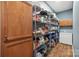 Spacious pantry includes a stand-alone freezer, brown cabinets, metal shelving, and ample storage space at 2090 Durand Rd, Fort Mill, SC 29715