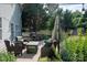 Outdoor patio featuring comfortable wicker furniture, a table, and surrounding greenery at 2090 Durand Rd, Fort Mill, SC 29715