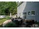 Rear exterior view showcasing the patio with seating, dining area, and grill near the house at 2090 Durand Rd, Fort Mill, SC 29715