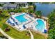 Aerial view of a community pool area with multiple pools, lounge chairs, and umbrellas for a relaxing summer day at 2090 Durand Rd, Fort Mill, SC 29715