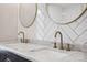 Close up of the double sink vanity featuring stone countertop and bronze fixtures at 2090 Durand Rd, Fort Mill, SC 29715
