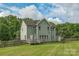 Large backyard with green lawn, wooden fence, and view of the surrounding trees at 2100 Darian Way, Waxhaw, NC 28173