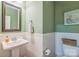 Charming half bath with a pedestal sink, white wainscoting, and decorative mirror at 2100 Darian Way, Waxhaw, NC 28173
