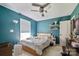 Bedroom with a ceiling fan and bright window with a wooden frame bed at 2100 Darian Way, Waxhaw, NC 28173