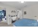 Bright bedroom featuring a stylish desk, walk-in closet, and modern decor at 2100 Darian Way, Waxhaw, NC 28173