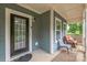 Inviting front porch with seating area, classic door, and ample natural light at 2100 Darian Way, Waxhaw, NC 28173