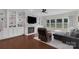 Stylish living room with custom built-ins, fireplace, and large windows overlooking the backyard at 2100 Darian Way, Waxhaw, NC 28173