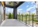 Outdoor balcony provides a relaxing view with black metal railings and community landscaping under a blue sky at 2523 Irwin Stream Rd, Charlotte, NC 28208