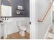 Charming half-bathroom with pedestal sink, decorative shelves, and modern fixtures at 2523 Irwin Stream Rd, Charlotte, NC 28208