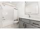 Clean bathroom featuring a shower over tub with white subway tile and a gray vanity with matte black hardware at 2523 Irwin Stream Rd, Charlotte, NC 28208