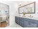 Modern bathroom features double vanity, blue cabinets, bronze fixtures, and marble tile at 2523 Irwin Stream Rd, Charlotte, NC 28208