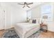Comfortable bedroom features a cozy queen bed, ceiling fan, and bright natural light from two windows at 2523 Irwin Stream Rd, Charlotte, NC 28208