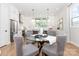 Modern dining area with stylish gray chairs and open to the kitchen with stainless steel appliances at 2523 Irwin Stream Rd, Charlotte, NC 28208