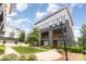 Modern brick townhome with a well-manicured lawn and sidewalk in a community setting at 2523 Irwin Stream Rd, Charlotte, NC 28208