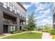 Modern townhome exterior with brick, balconies, large windows, and landscaping for a vibrant and welcoming curb appeal at 2523 Irwin Stream Rd, Charlotte, NC 28208
