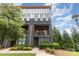 Stunning three-story home with modern design, a two-story balcony, and attractive landscaping at 2523 Irwin Stream Rd, Charlotte, NC 28208