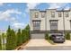 Townhome featuring an attached garage and driveway framed by neat landscaping, enhancing its residential appeal at 2523 Irwin Stream Rd, Charlotte, NC 28208