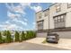 Attached garage and private driveway for a townhome, complemented by tidy landscaping and community charm at 2523 Irwin Stream Rd, Charlotte, NC 28208