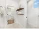 Hallway with shelving, coat hooks, hardwood floors, and a door to the bathroom at 2523 Irwin Stream Rd, Charlotte, NC 28208