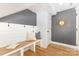 Inviting hallway features a built-in bench, coat hooks, and a decorative mirror creating a welcoming space at 2523 Irwin Stream Rd, Charlotte, NC 28208