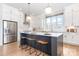 Modern kitchen with a large island, white cabinets, and stainless steel appliances at 2523 Irwin Stream Rd, Charlotte, NC 28208