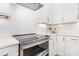 Modern kitchen features white cabinetry, herringbone tile backsplash, and stainless steel Profile oven at 2523 Irwin Stream Rd, Charlotte, NC 28208