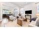 Open-concept living room with hardwood floors, white walls, and a view into the dining and kitchen area at 2523 Irwin Stream Rd, Charlotte, NC 28208