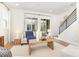 Cozy living room featuring a plush sofa, stylish decor, and a staircase at 2523 Irwin Stream Rd, Charlotte, NC 28208