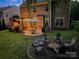 Inviting backyard featuring a stone patio, pergola with string lights, and a cozy fire pit area with chairs at 3006 S Legacy Park Blvd, Indian Land, SC 29707