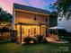 Backyard featuring a stone patio and a charming pergola with lights, creating a perfect outdoor space at 3006 S Legacy Park Blvd, Indian Land, SC 29707