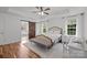 Bedroom featuring a king bed, wood floors, and a view into the ensuite bathroom at 3006 S Legacy Park Blvd, Indian Land, SC 29707