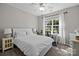 Cozy bedroom with a comfortable bed, a ceiling fan, and a bright window with sheer curtains at 3006 S Legacy Park Blvd, Indian Land, SC 29707