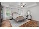 Spacious bedroom with a king bed, tray ceiling, bench, and great natural lighting at 3006 S Legacy Park Blvd, Indian Land, SC 29707