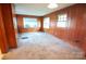 Wood paneled bedroom with two windows and carpeted floors offers classic comfort at 3220 Harmony Hwy, Harmony, NC 28634
