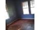 Bright bedroom featuring original hardwood floors and a bank of windows at 3220 Harmony Hwy, Harmony, NC 28634