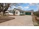Charming home features a well-maintained exterior with a spacious driveway and a green garage door at 3220 Harmony Hwy, Harmony, NC 28634