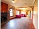 Spacious living room with a brick fireplace and hardwood floors needs some TLC at 3220 Harmony Hwy, Harmony, NC 28634