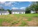 Expansive backyard with lush greenery, a gentle slope, and plenty of space to relax at 3486 Winters St, Newton, NC 28658