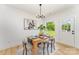 Bright dining area with modern chandelier, table with four chairs and view of landscaped backyard at 3486 Winters St, Newton, NC 28658