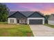 Charming one-story home featuring a gray roof, attached two-car garage, and a well-manicured lawn at 3486 Winters St, Newton, NC 28658