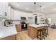 Modern kitchen featuring a spacious island with seating, white cabinets, and stainless steel appliances at 3486 Winters St, Newton, NC 28658
