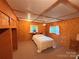 Spacious bedroom with exposed plywood, two windows, and ceiling fan at 370 Miracle Dr, Salisbury, NC 28146
