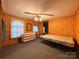 This bedroom features wood paneling, a ceiling fan, and a dresser at 370 Miracle Dr, Salisbury, NC 28146