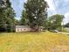 Exterior view of home with a large lawn, mature trees, and a car in the driveway at 370 Miracle Dr, Salisbury, NC 28146