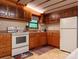 Classic kitchen with oak cabinetry, white appliances, and ample counter space for cooking prep at 370 Miracle Dr, Salisbury, NC 28146