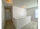 Bright upstairs hallway with neutral paint and soft carpet at 3933 Cameron Creek Dr, Matthews, NC 28105